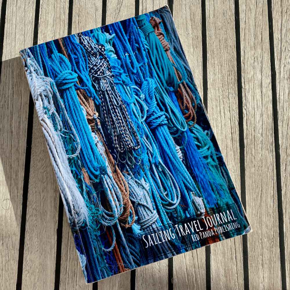 Ropes, Sheets, and Dock Lines Sailing Travel Journal Cover in Paperback shown with teak deck in the background
