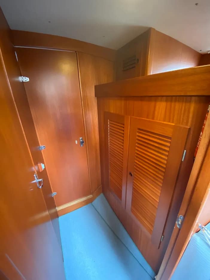 Heading towards the bow, there is a passageway between the forward cabin and saloon which houses a double wardrobe to starboard with a cupboard above and also extra storage space that is open. Heading towards the bow, there is a passageway between the forward cabin and saloon which houses a double wardrobe to starboard with a cupboard above and also extra storage space that is open.