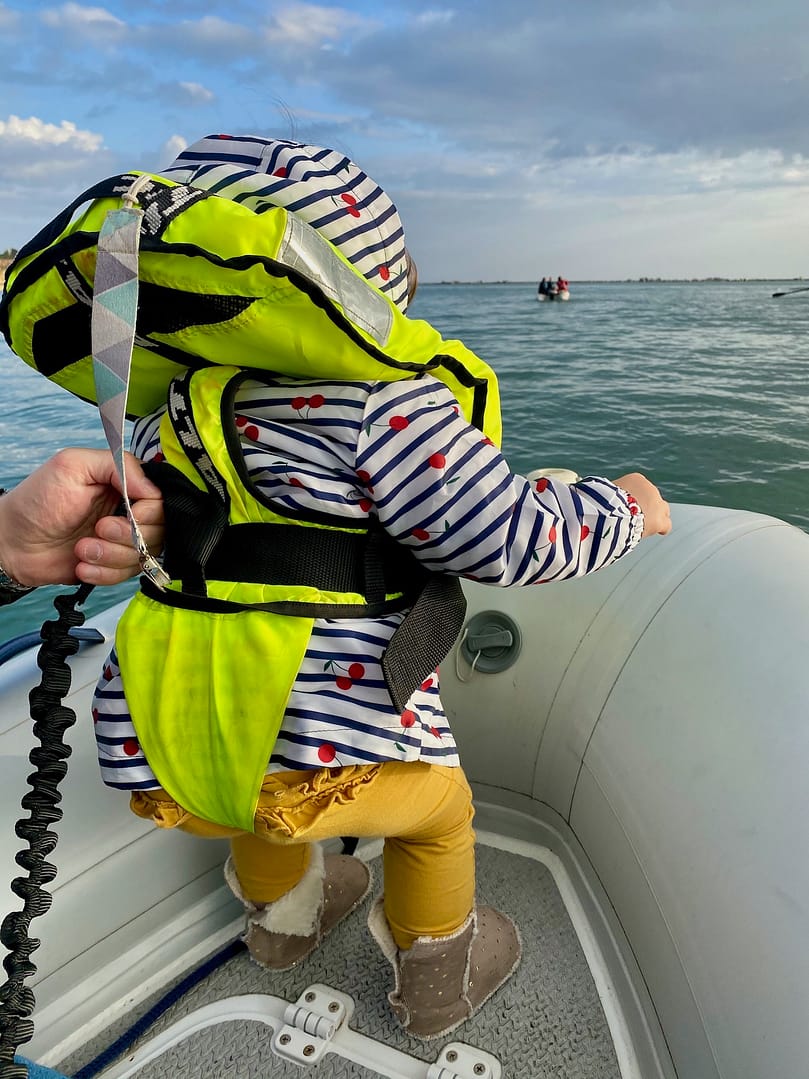 Toddler wearing a Bambi Baltic lifejacket on a sailboat Toddler wearing a Bambi Baltic lifejacket on a sailboat